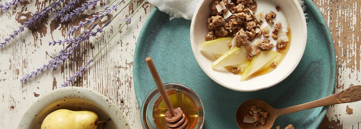 A bowl of Autumn's Gold granola with yogurt and apples
